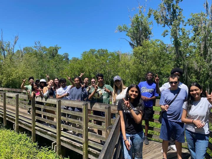 Bulls L.E.A.D. cohort members gathered along a wooden boardwalk outdoors