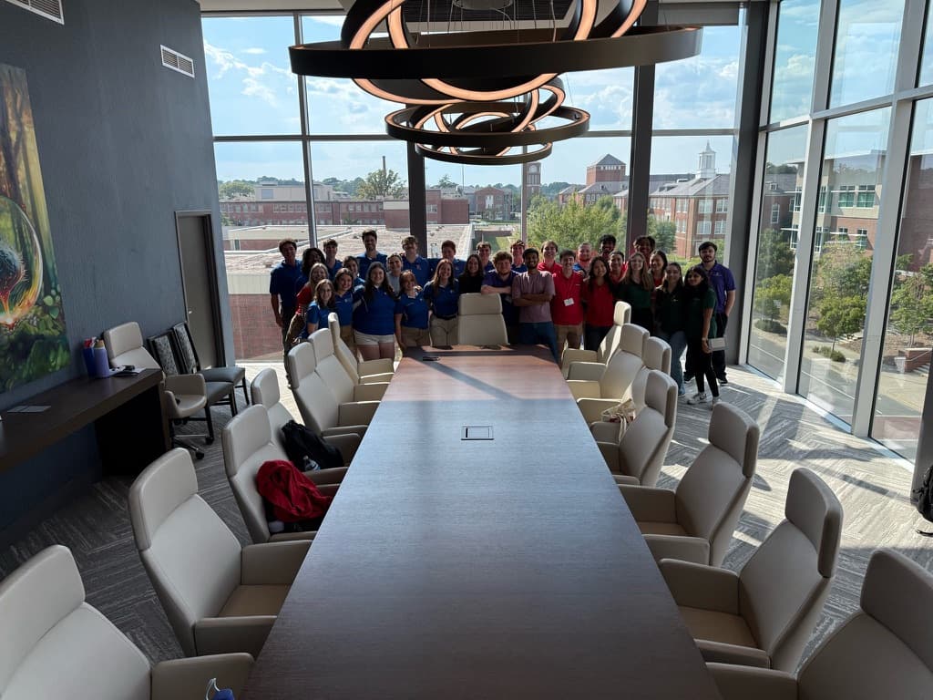 Engineering community members gathered around a conference table