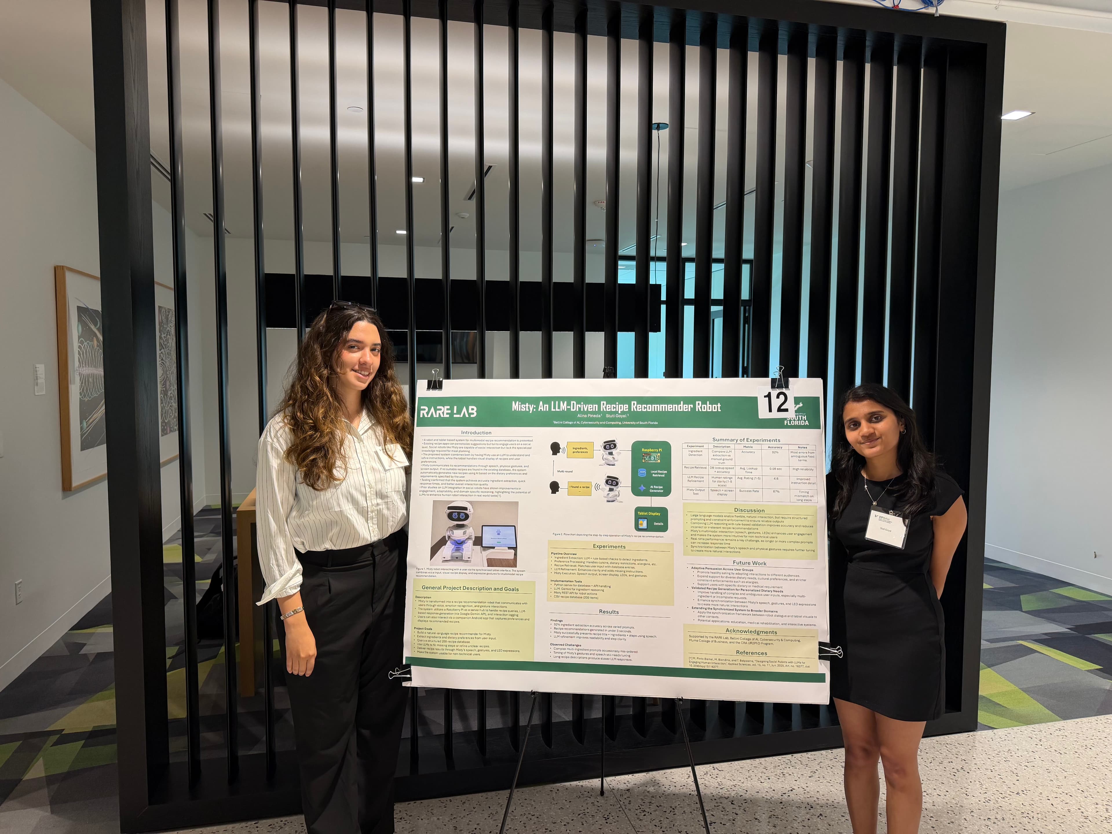 Stuti and a fellow researcher presenting their Misty recipe recommender robot poster
