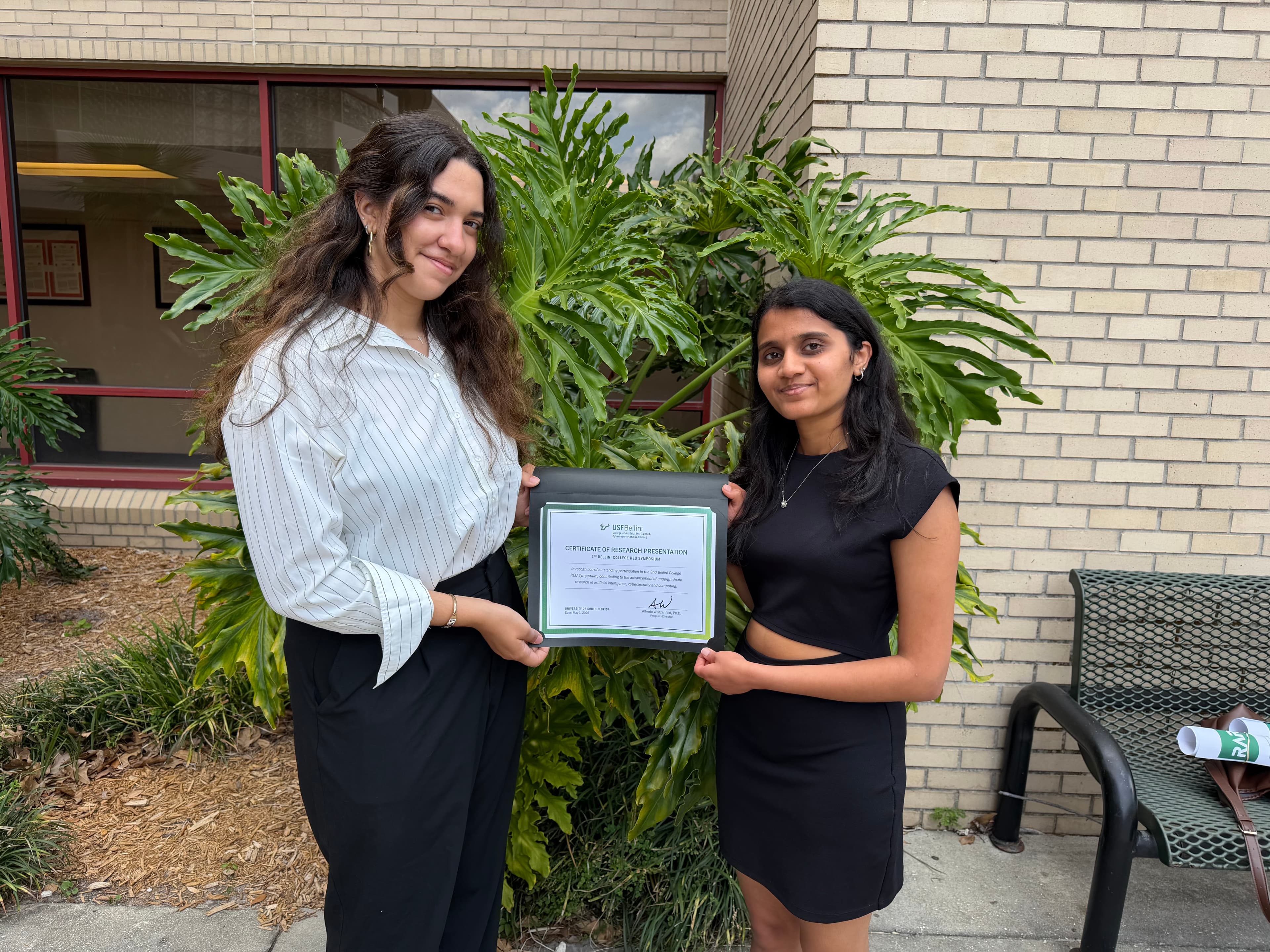 Stuti and a fellow researcher holding a certificate of research presentation