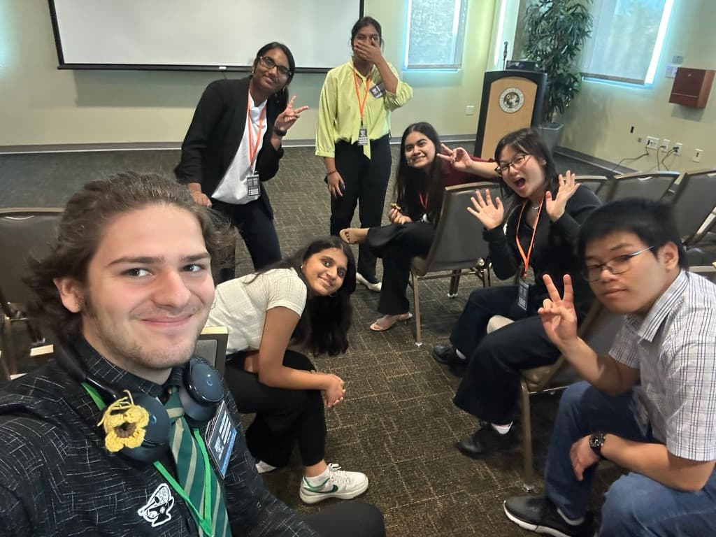 SASE conference attendees posing together in a classroom